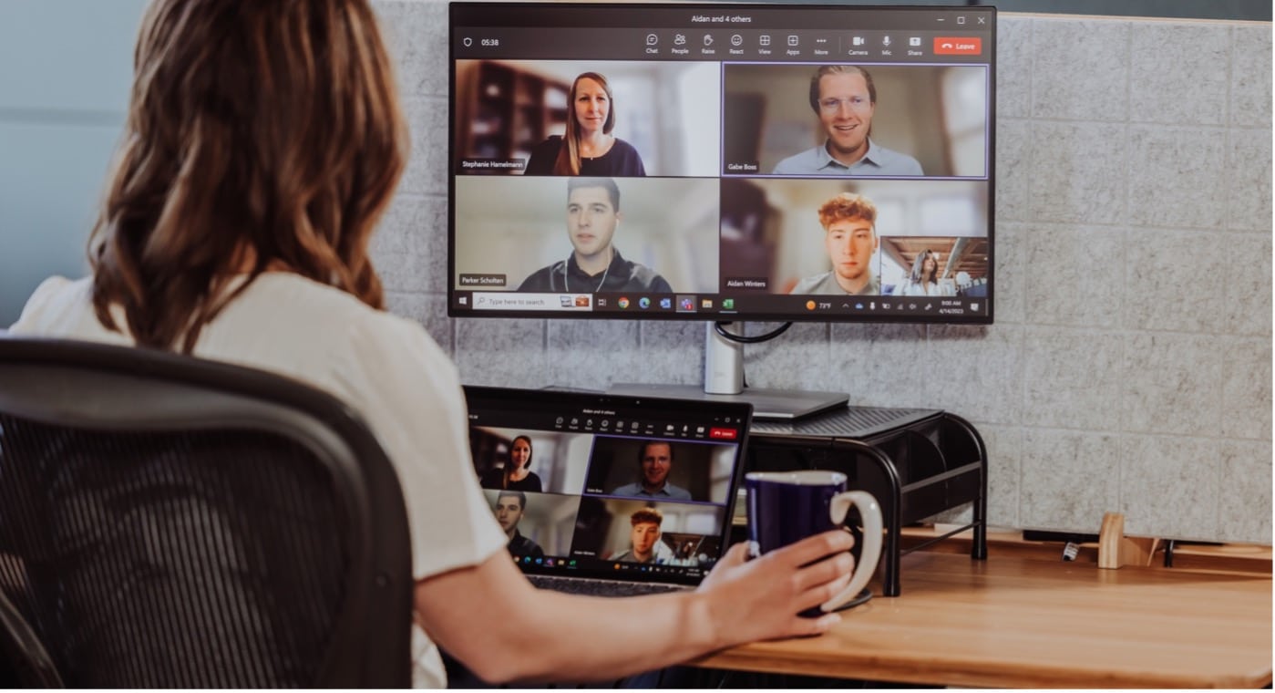 A talent solutions recruiter chats with colleagues on a video conference call