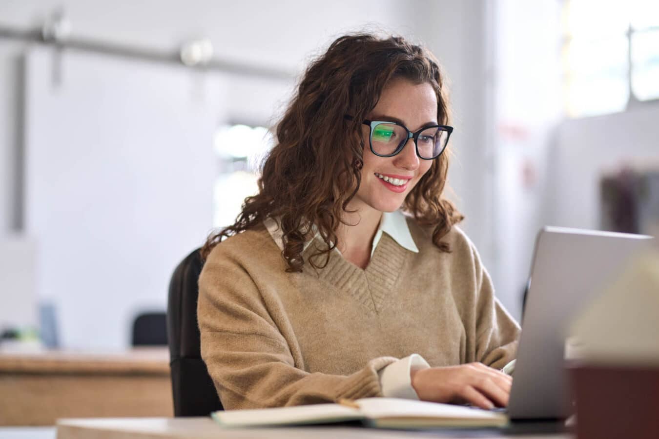 Woman smiling and looking at her computer