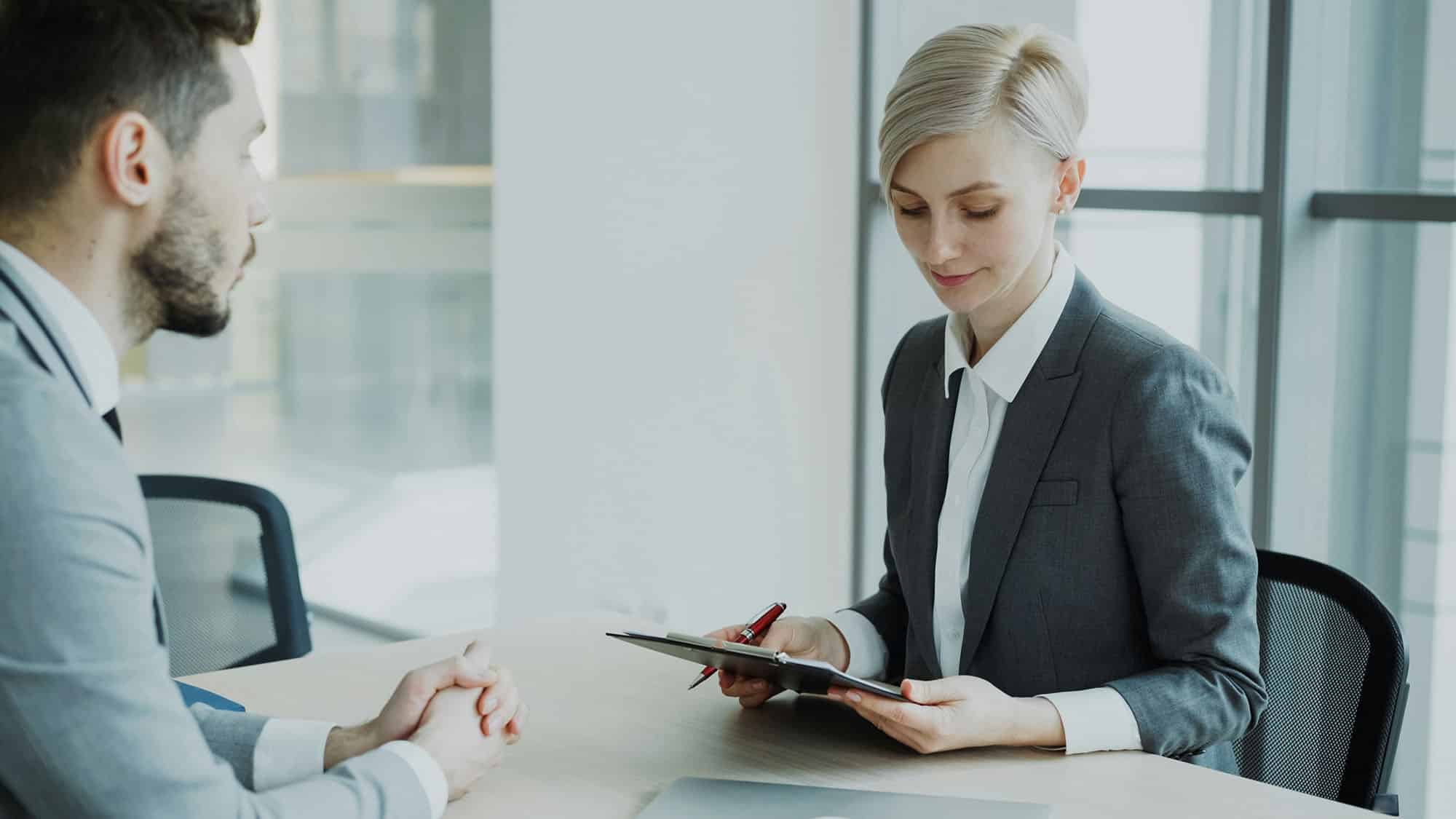 Hiring manager reviewing notes during a candidate interview